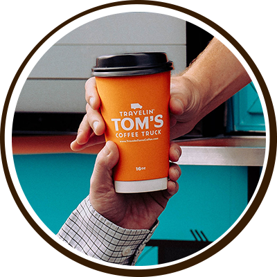 hot_beverages_toms Closeup of a person’s hands holding a hot specialty coffee drink from Travelin’ Tom’s Coffee Truck